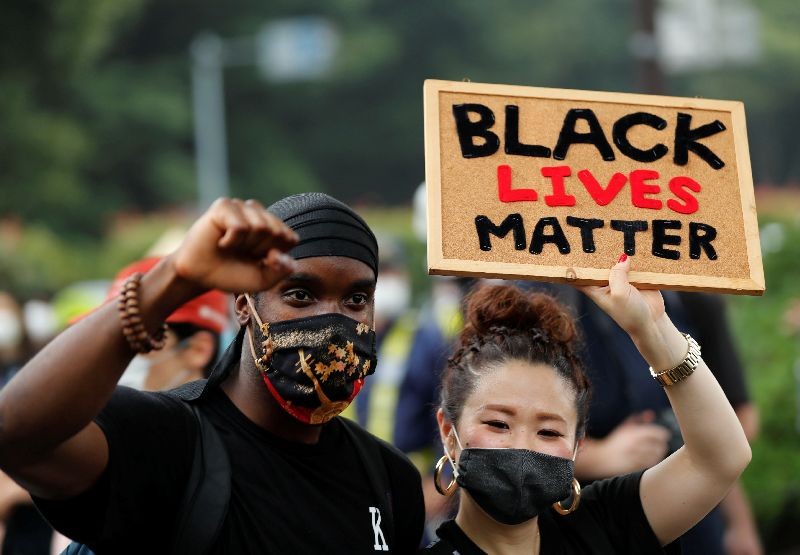 People wearing face masks march during a Black Lives Matter protest following the death in Minneapolis police custody of George Floyd, in Tokyo, Japan June 14, 2020. REUTERS/Kim Kyung-Hoon